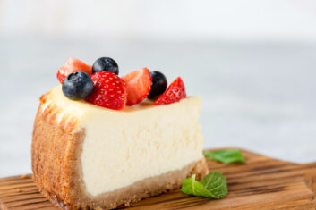New York cheesecake slice topped with fresh berries