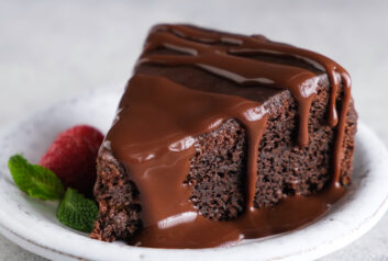 Slice of chocolate brownie cake with chocolate glaze